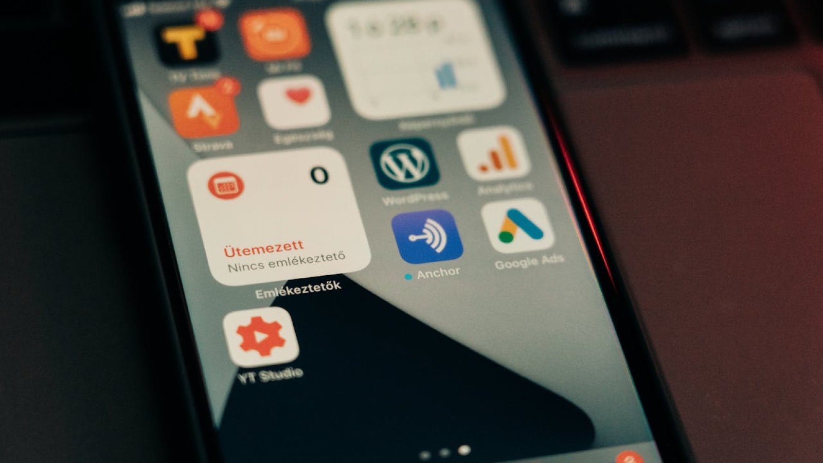 Close-up view of smartphone screen featuring various app icons and notifications.